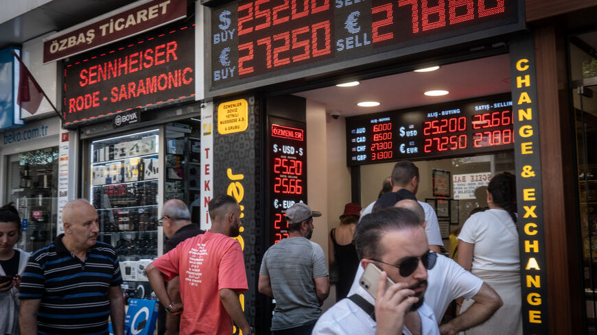 People wait to exchange money at a currency exchange shop on June 23, 2023 in Istanbul, Turkey. The Turkish Lira weakened to a record low of 25.74 against the dollar, a day after the central bank hiked interest rates from 8.5 percent to 15 percent in the first rate decision since the appointment of new central bank governor Hafize Gaye Erkan and the re-election of President Recep Tayyip Erdogan last month. (Photo by Chris McGrath/Getty Images)