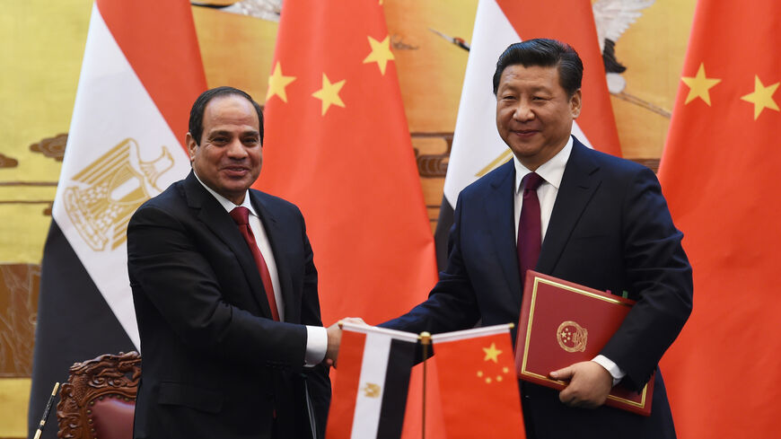 Egypt's President Abdel Fattah al-Sisi (L) greets Chinese President Xi Jinping (R) during a signing ceremony at the Great Hall of the People on December 23, 2014 in Beijing, China. 