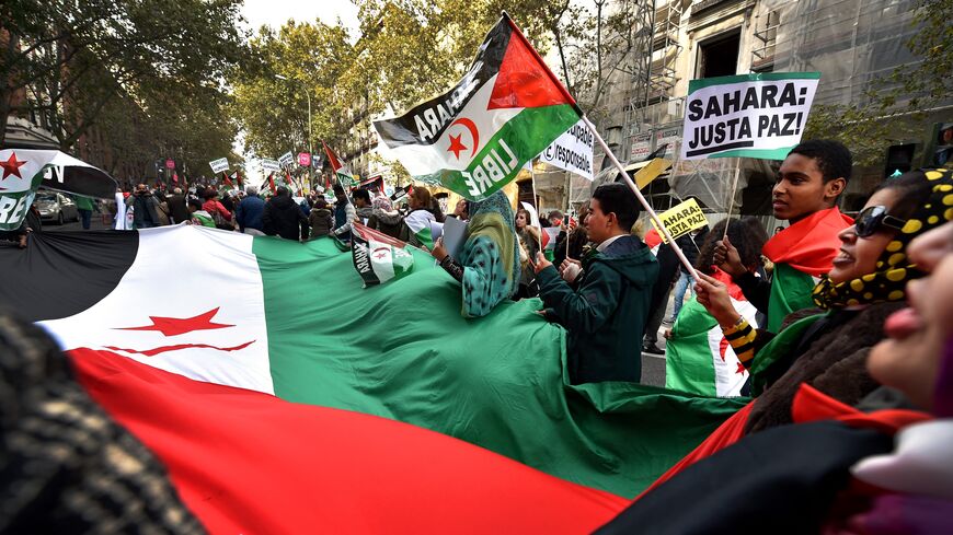 Activists for the independence of the Western Sahara wave flags and banners reading "Sahara: Only Pace!" during an annual protest organised by the state coordinator of associations of solidarity with the Sahara in Madrid on November 11, 2016 marking the 4th anniversary of the tripartite Madrid agreements demonstrators deem illegal. - The Western Sahara is a territory bordered by Morocco and Algeria and disputed by Spain and Morocco who both claiming sovereignty. (Photo by GERARD JULIEN / AFP) (Photo by GERA