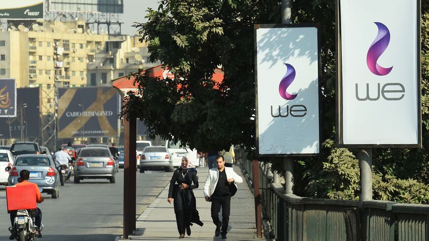 A picture taken on October 31, 2017 shows advertising billboards in Cairo for "WE" a new mobile service from Egypt's state-owned company Telecom Egypt. In a country with more mobile phone subscriptions than residents, Egypt's only fixed-line operator is hoping to get in on the action with its new mobile service, WE. / AFP PHOTO / MOHAMED EL-SHAHED (Photo credit should read MOHAMED EL-SHAHED/AFP via Getty Images)
