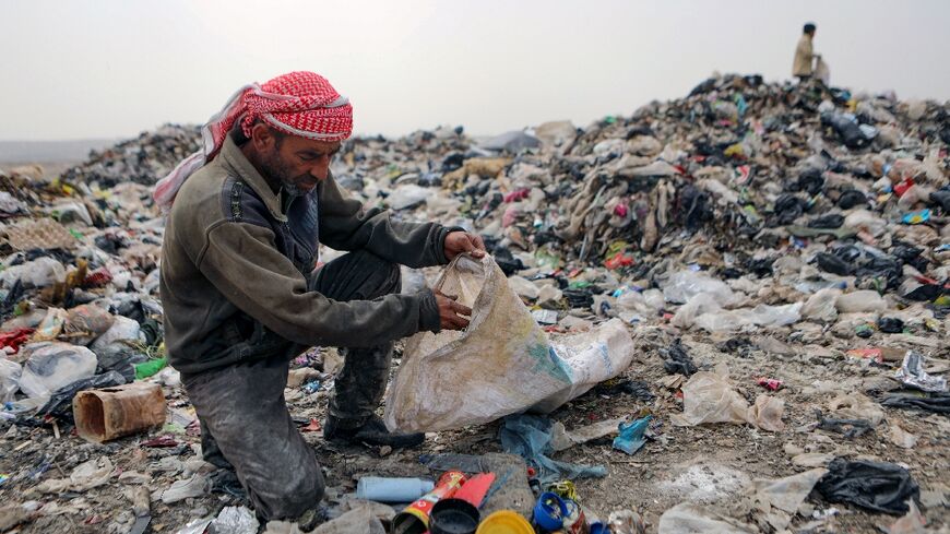 Abu Mohammed sifts through rubbish at a dump near the village of Hazreh