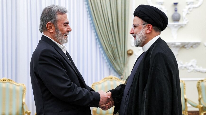 Iran's President Ebrahim Raisi (R) receives Ziad al-Nakhala, Secretary-General of the Palestinian Islamic Jihad movement