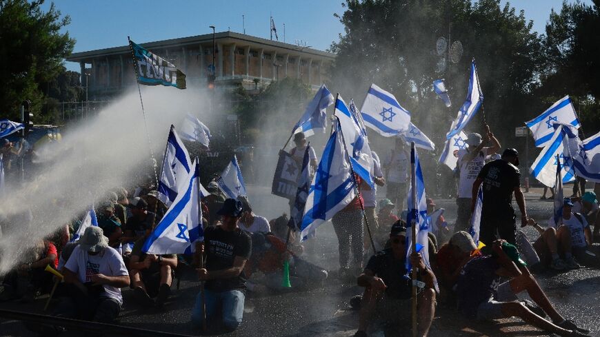 Israeli security forces used water cannon to disperse protesters blocking the entrance to parliament