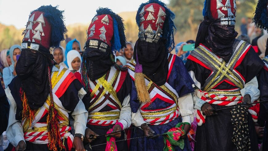 Men perform a traditional dance during the Sebeiba Festival, a yearly celebration of Tuareg culture, in the oasis town of Djanet in southeastern Algeria, on July 29, 2023