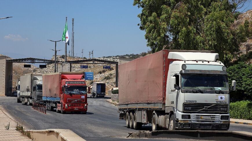 A picture taken on July 28, 2022 shows the entry of a United Nations aid convoy through the Bab al-Hawa border crossing with Turkey
