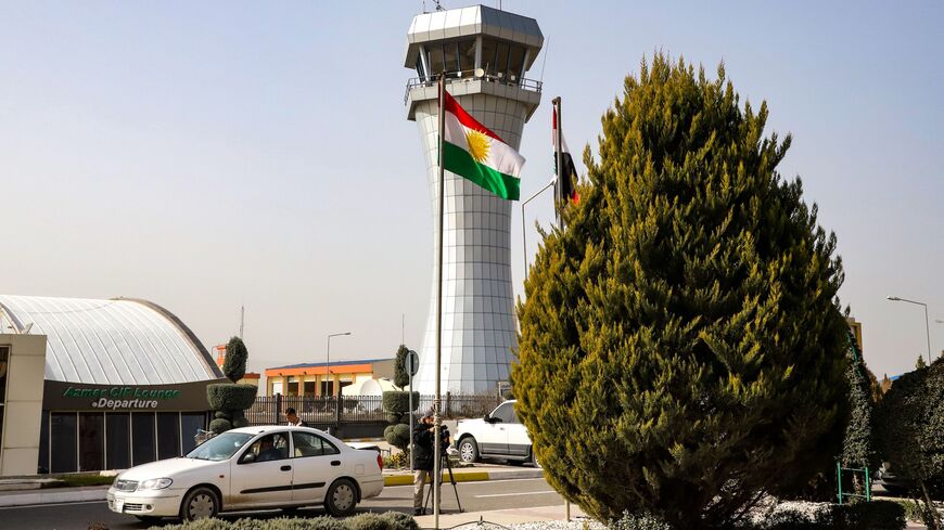 This picture taken on Jan. 26, 2019, shows journalists filming outside the departure lounge and control tower of Sulaimaniyah International Airport.
