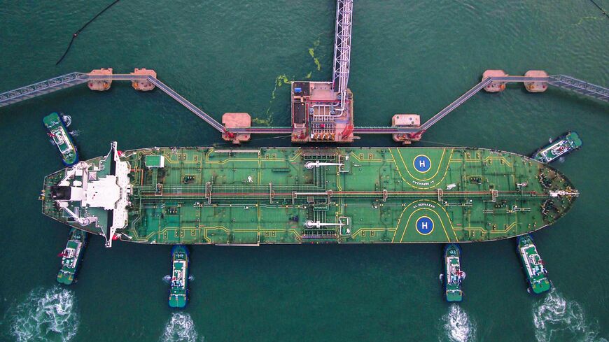 This aerial photo taken on August 4, 2019 shows tugboats berthing an oil tanker at Qingdao port in Qingdao in China's eastern Shandong province. - China's good shipments abroad beat expectations to rise in July while its purchases continued to shrink, official data showed on August 8. (Photo by AFP) / China OUT (Photo by STR/AFP via Getty Images)