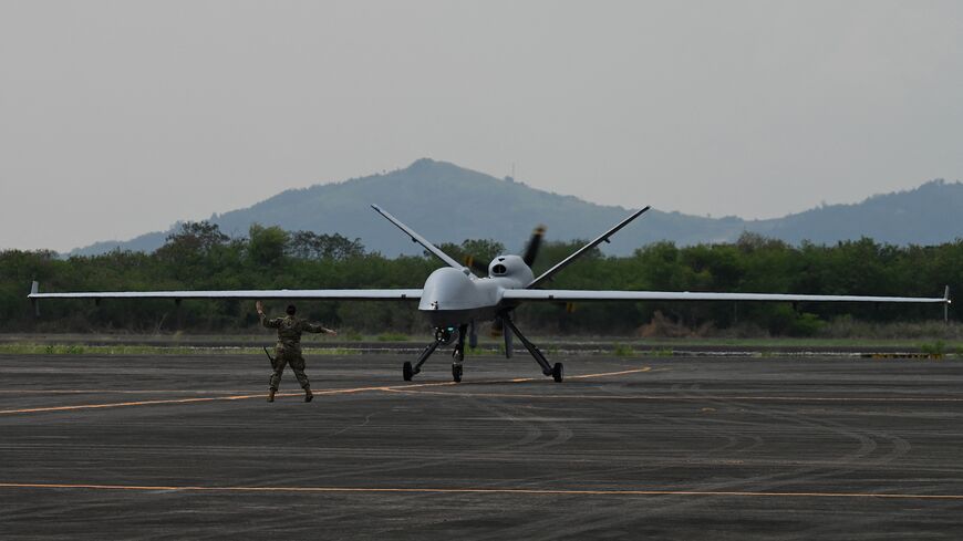 A US soldier guides the MQ-9 Reaper drone as it lands at Subic Bay Freeport Zone on April 23, 2023, as part of the US-Philippines joint military exercise 'Balikatan'. (Photo by JAM STA ROSA / AFP) (Photo by JAM STA ROSA/AFP via Getty Images)