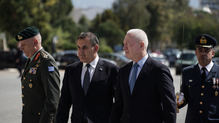 The Incubent Chief of the Hellenic National Defence General Staff General Konstantinos Floros (L),Greece's Minister of Defence Nikos Panagiotopoulos (M) and his Israeli counterpart Yoav Gallant (R) review an honor guard prior to their meeting, at the Ministry of National Defence in Athens, Greece, on May 4, 2023 (Photo by Menelaos Myrillas / SOOC / SOOC via AFP) (Photo by MENELAOS MYRILLAS/SOOC/AFP via Getty Images)