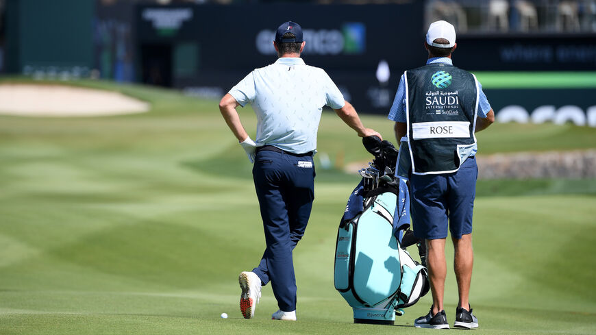 Justin Rose of England and his caddy look on, on the 9th hole during Day Four of the Saudi International.