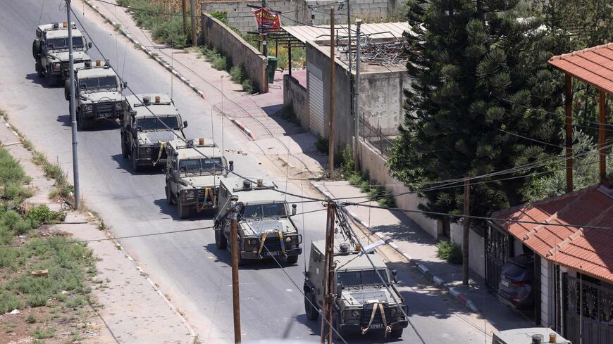 Israeli military armored vehicles advance on a road during an operation in Jenin city in the occupied West Bank, on July 3, 2023.