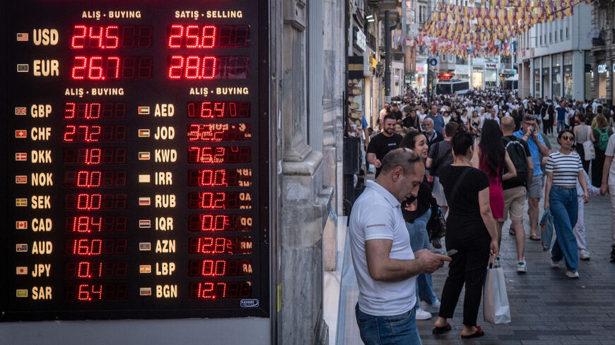 ISTANBUL, TURKEY - JUNE 23: People walk past a currency exchange shop on June 23, 2023 in Istanbul, Turkey. The Turkish Lira weakened to a record low of 25.74 against the dollar, a day after the central bank hiked interest rates from 8.5 percent to 15 percent in the first rate decision since the appointment of new central bank governor Hafize Gaye Erkan and the re-election of President Recep Tayyip Erdogan last month. (Photo by Chris McGrath/Getty Images)