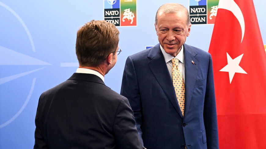 Turkish President Recep Tayyip Erdogan (R) shakes hands with Swedish Prime Minister Ulf Kristersson during their meeting ahead of the NATO Summit on July 11, 2023 in Vilnius, Lithuania. The summit is bringing together NATO members and partner countries heads of state from July 11-12 to chart the alliance's future, with Sweden's application for membership and Russia's ongoing war in Ukraine as major topics on the summit agenda. (Photo by Filip Singer - Pool/Getty Images)