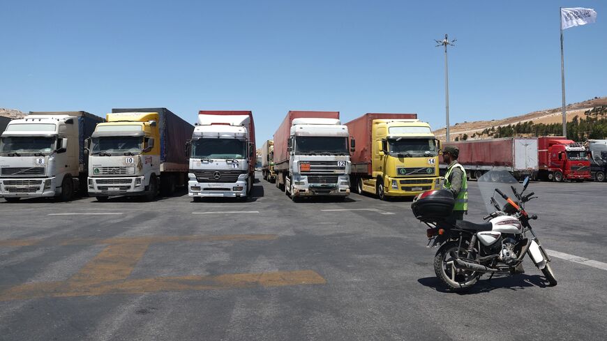 A convoy of trucks carrying humanitarian aid is seen parked after crossing the Syrian Bab al-Hawa border crossing with Turkey, on July 10, 2023. 