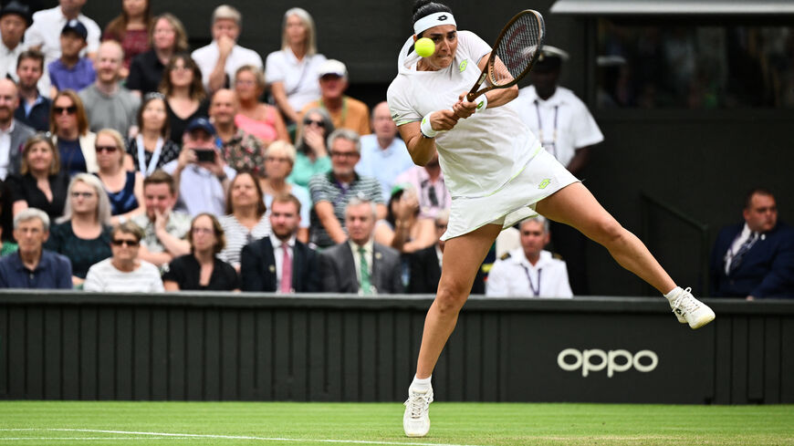Tunisia's Ons Jabeur returns the ball to Belarus's Aryna Sabalenka during their women's singles semi-finals tennis match on the eleventh day of the 2023 Wimbledon Championships at The All England Lawn Tennis Club in Wimbledon, southwest London, on July 13, 2023. (Photo by SEBASTIEN BOZON / AFP) / RESTRICTED TO EDITORIAL USE (Photo by SEBASTIEN BOZON/AFP via Getty Images)