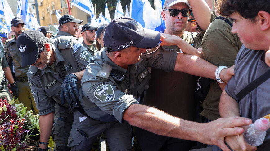 Members of Israeli security forces disperse demonstrators staging a 'day of resistance' to protest the government's judicial overhaul bill, in Tel Aviv on July 18, 2023. The proposals have divided the nation and triggered one of the biggest protest movements in Israel's history since being unveiled in January by the hard-right government of Prime Minister Benjamin Netanyahu. (Photo by JACK GUEZ / AFP) (Photo by JACK GUEZ/AFP via Getty Images)