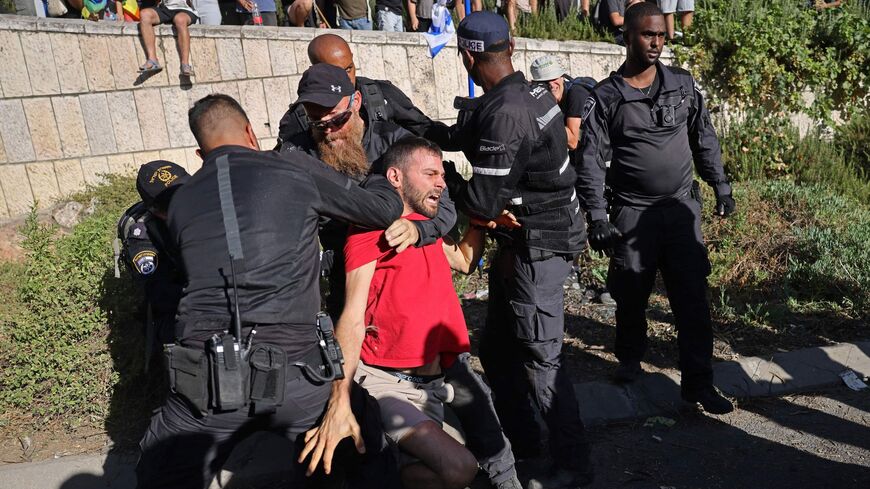 Israeli security forces detain a demonstrator near the Knesset.