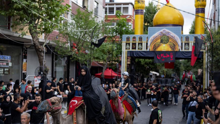Shia muslims attend the "Ashura" to commemorate the death of Shia Imam Husayn ibn Ali (a grandson of Muhammad) who died during the Battle of Karbala in 680 AD, in Istanbul on July 28, 2023. (Photo by YASIN AKGUL / AFP) (Photo by YASIN AKGUL/AFP via Getty Images)