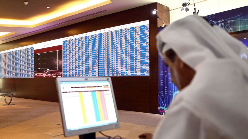 A Qatari trader prepares before the opening of the stock market at the Qatari stock exchange in Doha on July 31, 2017. / AFP PHOTO / STRINGER (Photo credit should read STRINGER/AFP via Getty Images)