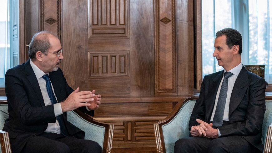 Syria's President Bashar al-Assad (R) meeting with Jordan's Foreign Minister Ayman Safadi in Damascus