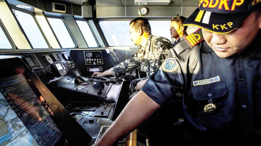 Security ship crew members of Ministry of Maritime Affairs and Fisheries monitor radar during a patrol in the South China Sea, Natuna, Ranai, Indonesia, Aug. 17, 2016.