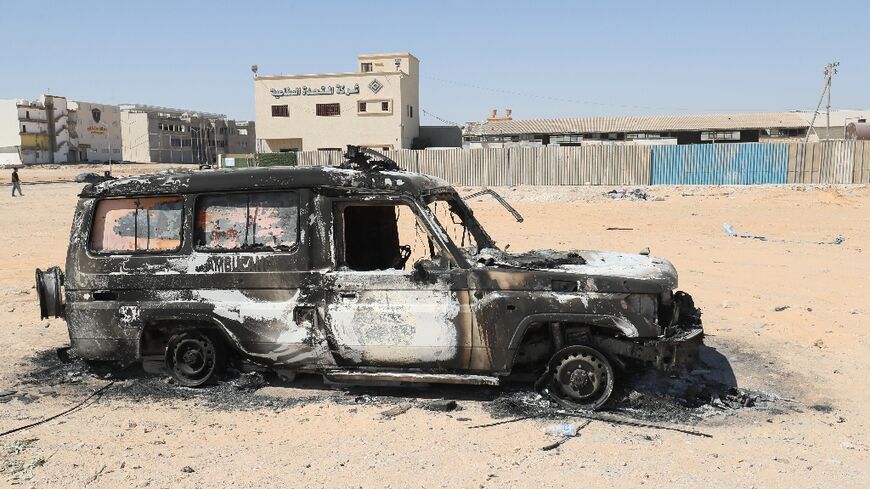 A car gutted by fire is pictured after two days of deadly clashes in Libya's capital