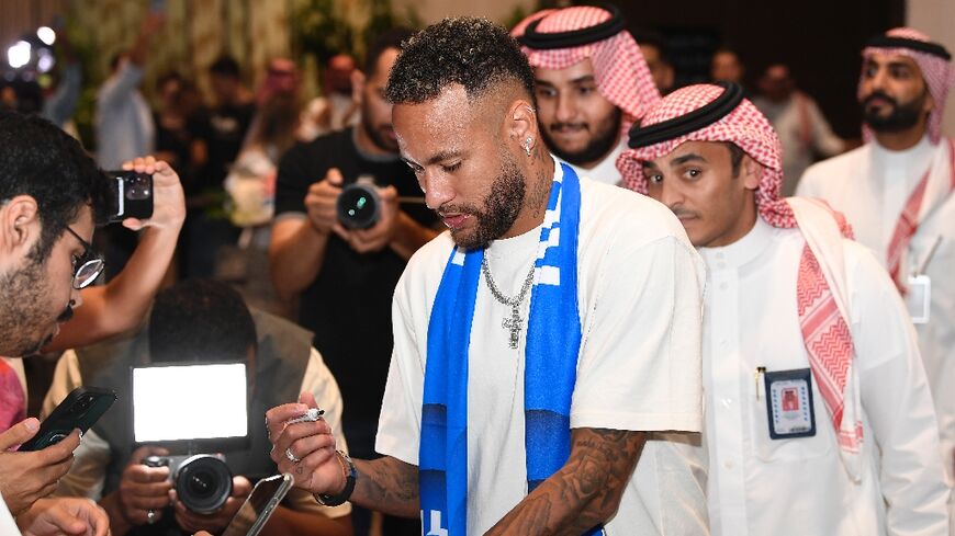 Neymar signs autographs as he arrives in Riyadh 