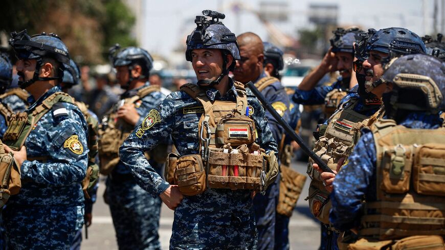 Iraqi security forces deploy near the gate of the green zone in Baghdad during a demonstration marking Labour Day on May 1, 2023, to demand a law establishing a salary grid to reduce pay inequalities for around 3 million government employees in the country. 