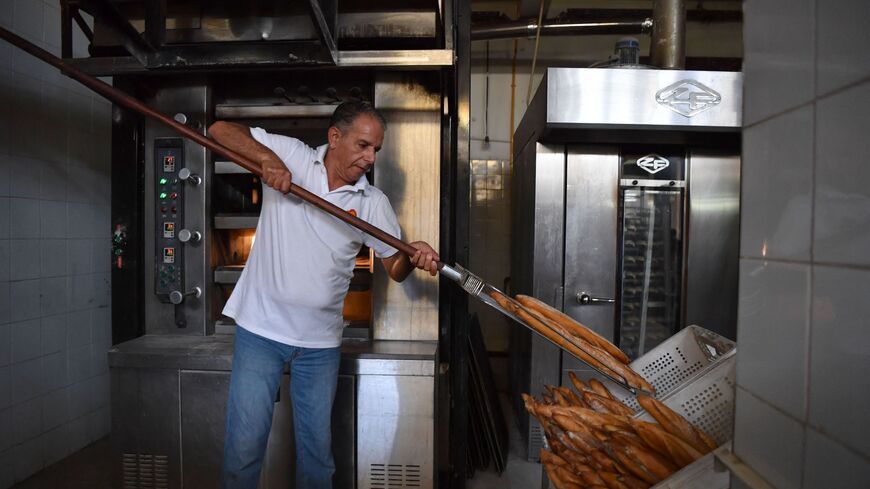 An employee works at a bakery selling baguettes in Tunis on August 7, 2023. (Photo by FETHI BELAID / AFP) (Photo by FETHI BELAID/AFP via Getty Images)