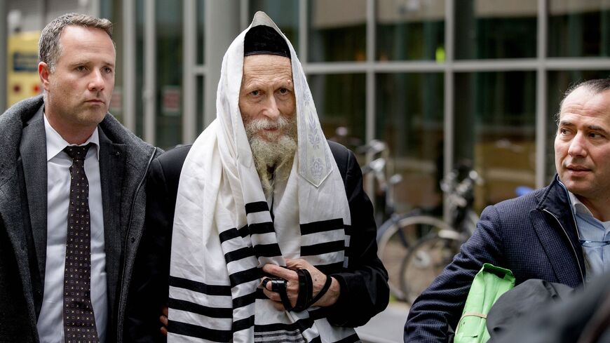 Israeli Rabbi Eliezer Berland (C), who is suspected of sexual abuse in Israel, arrives at court in Haarlem, on November 17, 2014, with his lawyer Louis de Leon (R). AFP PHOTO / ANP / SANDER KONING ++netherlands out++ (Photo credit should read Sander KONING/AFP via Getty Images)