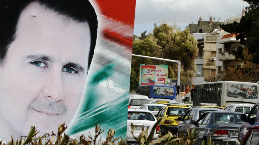 A photo taken on March 4, 2015 shows a banner bearing a portrait of Syrian President Bashar al-Assad in a street in the city of Damascus. 