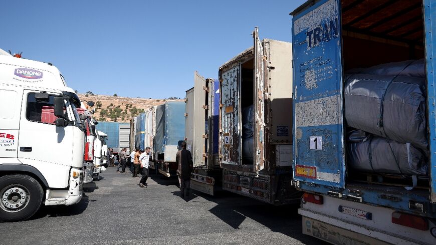 A convoy carrying humanitarian aid arrives in Syria after crossing the Bab al-Hawa border crossing with Turkey