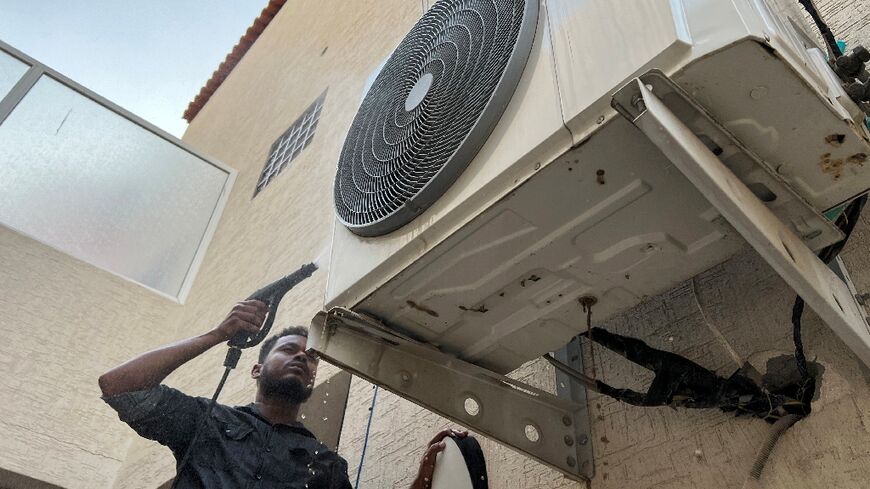 Air conditioning technicians clock long hours in the Saudi Arabian capital Riyadh, where summer temperatures daily top 40 degrees Celsius