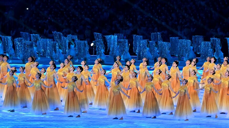 Performers take part in the opening ceremony of the Asian Games