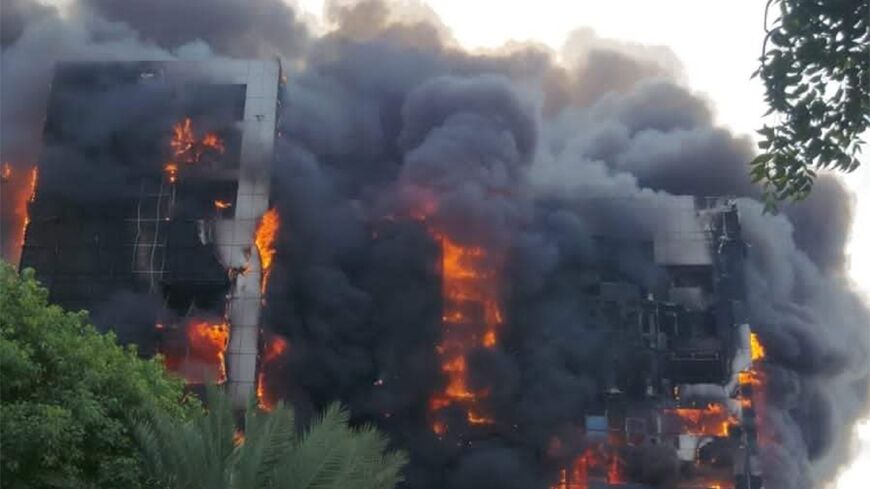 A fire rips through the Greater Nile Petroleum Oil Company Tower in Khartoum as battles between Sudanese rival forces rages in Khartoum 