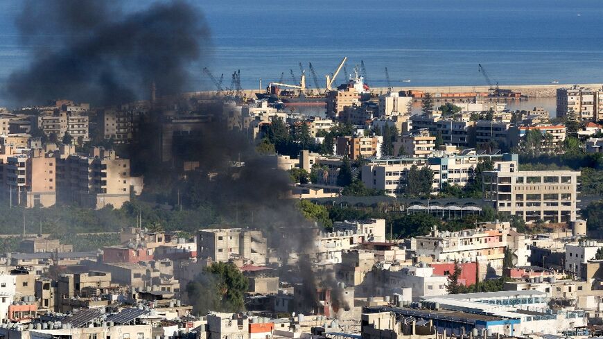 Smoke billows during clashes in the Palestinian refugee camp of Ain al-Helweh, in Lebanon's southern city of Sidon