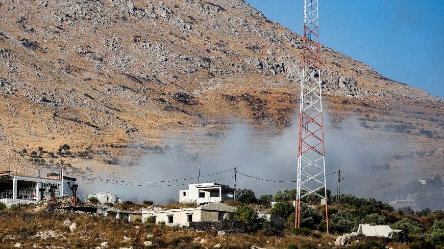 Smoke rises from a Syrian army position after an Israeli tank fires across the demarcation line from the occupied Golan Heights