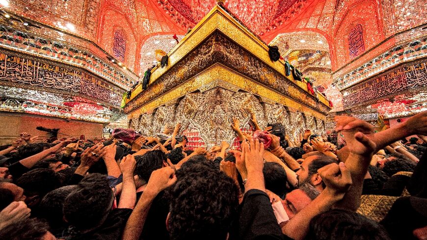 Shiite Muslim devotees at the tomb of Imam Hussein, the Prophet Mohammed's grandson, in Iraq's central holy city of Karbala