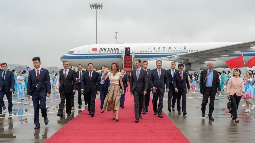 Assads arrive in China