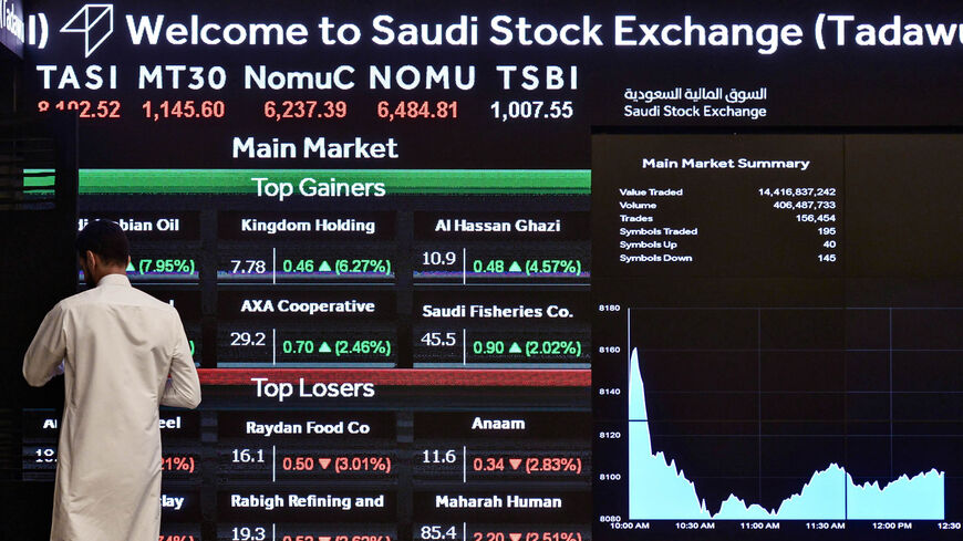 A man monitors the board at the Stock Exchange Market (Tadawul) bourse in Riyadh, Saudi Arabia, Dec. 12, 2019.