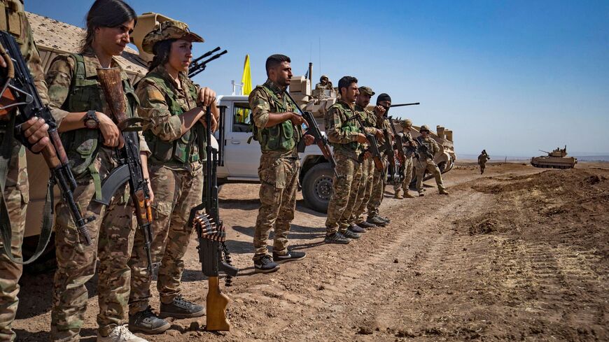 Fighters of the Syrian Democratic Forces (SDF) attend a joint military exercise with forces of the US-led "Combined Joint Task Force-Operation Inherent Resolve" coalition against the Islamic State (IS) group in the countryside of the town of al-Malikiya (Derik in Kurdish) in Syria's northeastern Hasakah province on September 7, 2022. 