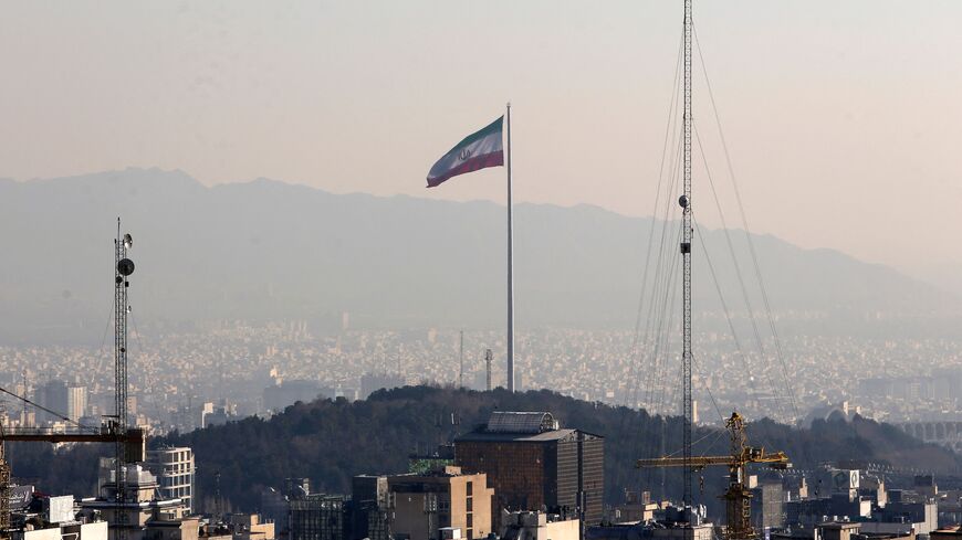 A general view shows the Iranian capital Tehran on January 7, 2023, with the Iranian flag fluttering in the wind. (Photo by ATTA KENARE / AFP) (Photo by ATTA KENARE/AFP via Getty Images)