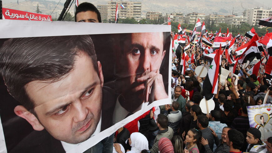 Tens of thousands of people rally in support of Syrian President Bashar al-Assad in Damascus on October 26, 2011, as an Arab delegation led by Qatar was headed for Syria for mediation between the Syrian government and its opponents. The demonstrators, waving Syrian flags and brandishing pictures of Assad and his brother Maher (L), swarmed to Omayyad square in the heart of Damascus. AFP PHOTO/LOUAI BESHARA (Photo credit should read LOUAI BESHARA/AFP via Getty Images)