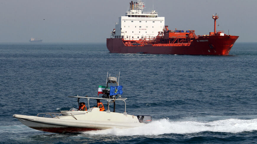 An Iranian Revolutionary Guard speedboat cruises past an oil tanker off the port of Bandar Abbas, southern Iran, on July 2, 2012. Iran has come up with several methods to foil the European insurance embargo on ships loaded with its crude, a sanction which may harm its vital exports as much as the EU oil embargo itself. AFP PHOTO/ATTA KENARE (Photo credit should read ATTA KENARE/AFP/GettyImages)