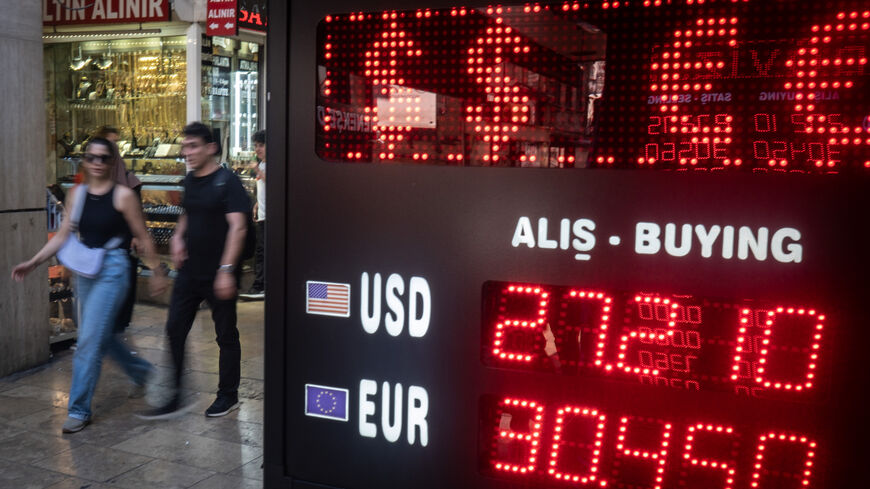 ISTANBUL, TURKEY - JULY 19: People walk past a currency exchange office on July 19, 2023 in Istanbul, Turkey. For the second day in a row the Turkish Lira hit a new record low of 27.00 Lira to the US Dollar ahead of the July 20, 2023 Central Bank interest rate announcement. (Photo by Chris McGrath/Getty Images)