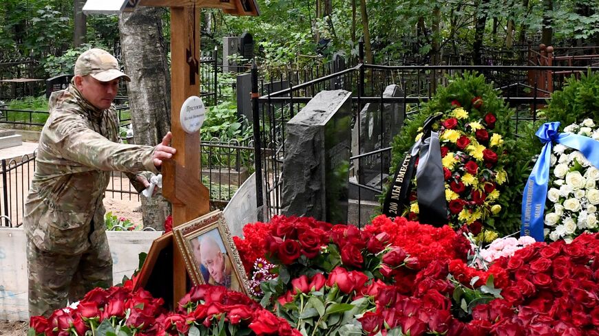 A man wearing camouflage visits the grave of Wagner private mercenary group chief Yevgeny Prigozhin, who was killed in a private jet crash in the Tver region last week, at the Porokhovskoye cemetery in Saint Petersburg on August 30, 2023. (Photo by Olga MALTSEVA / AFP) (Photo by OLGA MALTSEVA/AFP via Getty Images)