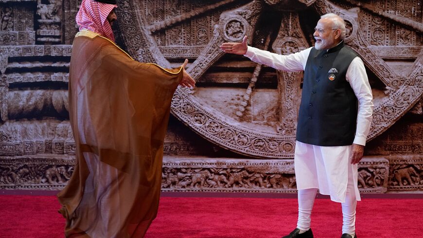 India's Prime Minister Narendra Modi (R) shakes hand with Saudi Arabia's Crown Prince and Prime Minister Mohammed bin Salman ahead of the G20 Leaders' Summit in New Delhi on September 9, 2023. (Photo by Evan Vucci / POOL / AFP) (Photo by EVAN VUCCI/POOL/AFP via Getty Images)