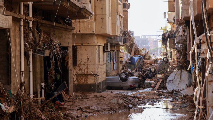 Overturned cars lay among other debris caused by flash floods in Derna, eastern Libya, on Sept. 11, 2023. 
