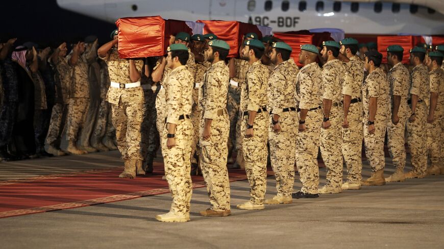 Members of the Bahraini armed forces carry the coffins of comrades who were killed the previous day during their battle against the Huthi rebels in Yemen, on September 5, 2015 during an official repatriation ceremony at Isa Air Base in Sakhir, South of Manama. Bahrain announced that five of its soldiers were killed in southern Saudi Arabia where they had been posted to help defend the border with neighbouring war-wracked Yemen. AFP PHOTO / MOHAMMED AL-SHAIKH (Photo credit should read MOHAMMED AL-SHAIKH/AFP 