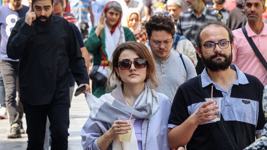 People walk outside Tehran's Grand Bazaar, nearly a year after Mahsa Amini's death that triggered nationwide protests